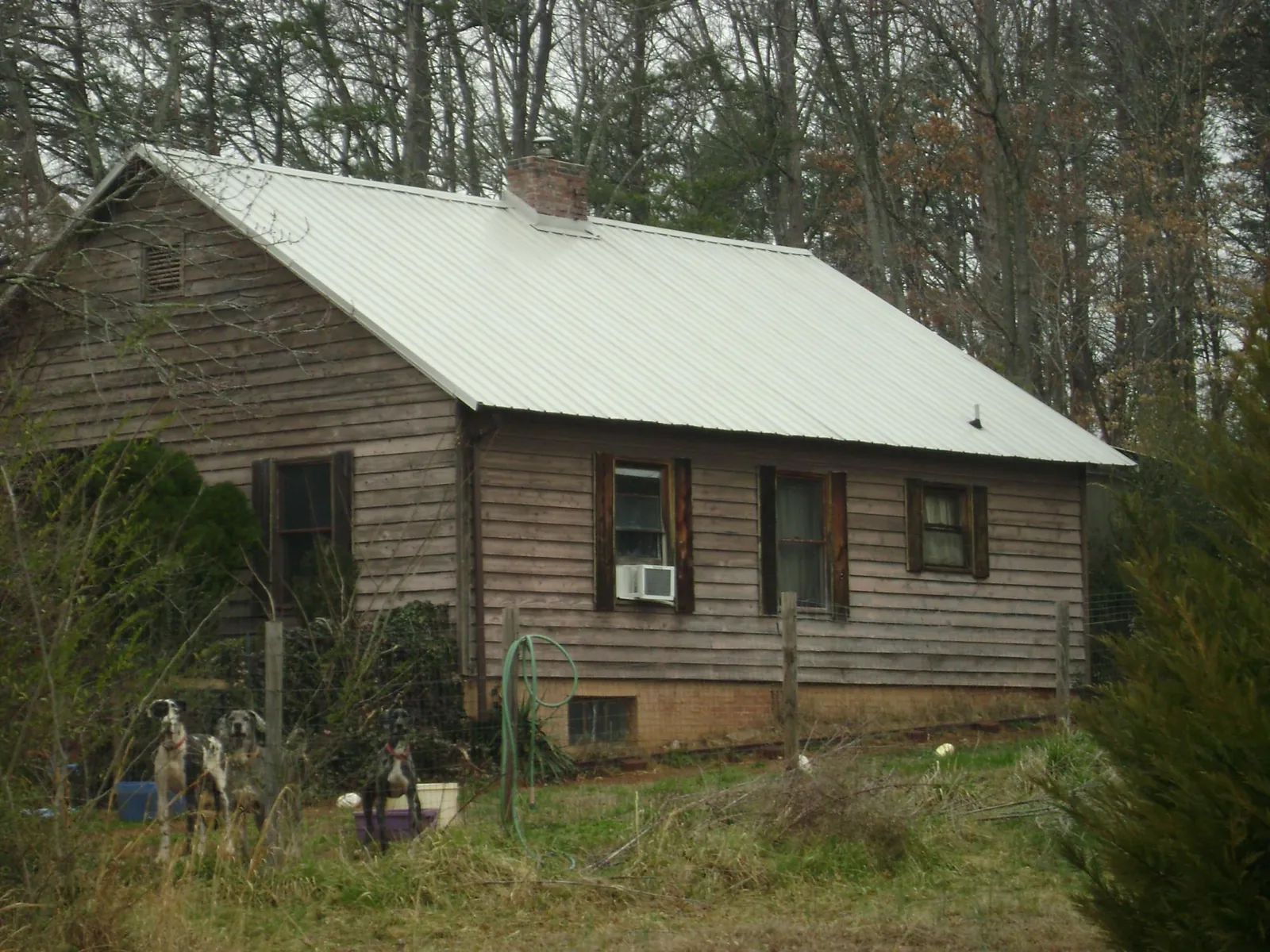 White metal roof on an old wood sided farmhouse, from a Asphalt Shingle Roof Repair job in Hales Corners